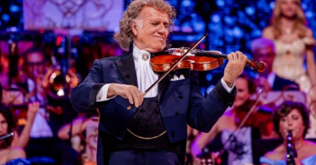 Andre Rieu  in a tuxedo performing on the violin, capturing the essence of Andre Rieu's musical artistry.