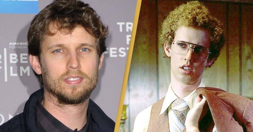 Jon Heder  with curly hair and glasses stands beside another man wearing glasses, reminiscent of Jon Heder's style.